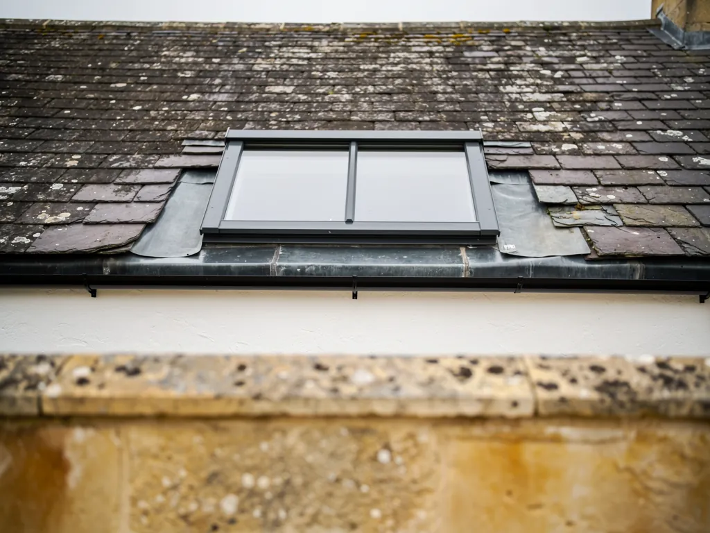 A conservation rooflight with lead flashing on a listed townhouse roof