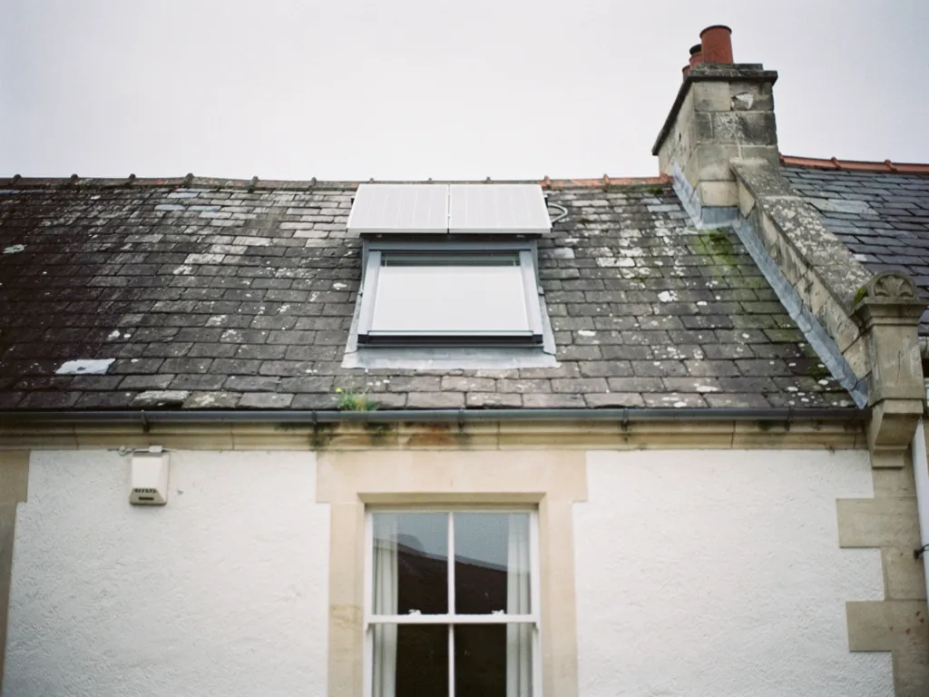 A solar-powered roof window with its small panel