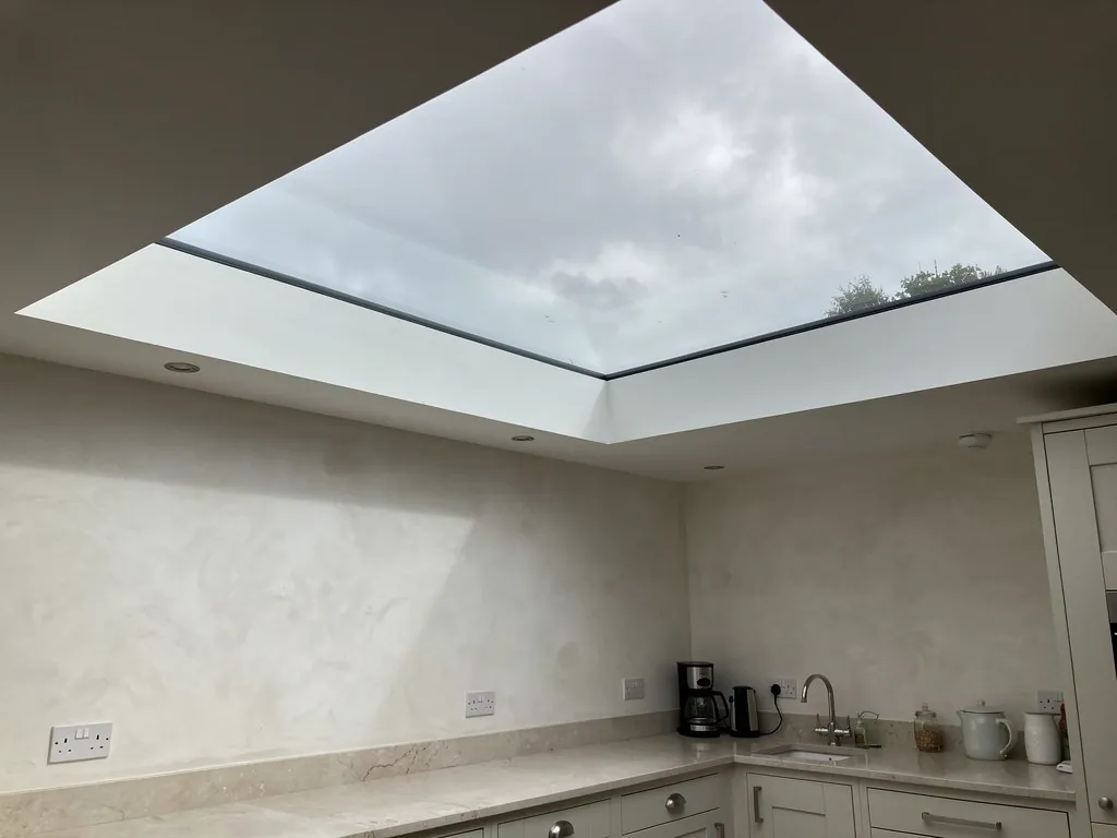 A frameless flat rooflight over a kitchen extension