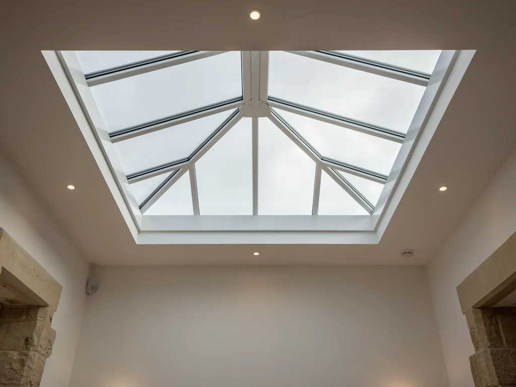 A roof lantern seen from below, its ridge and hip bars above the ceiling opening of a kitchen