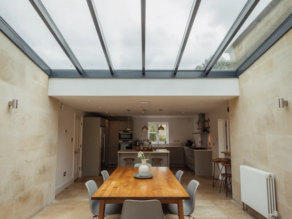 A long roof lantern over a dining table
