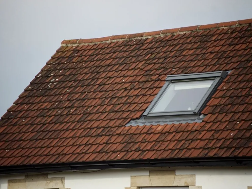 A roof window in a clay tiled roof