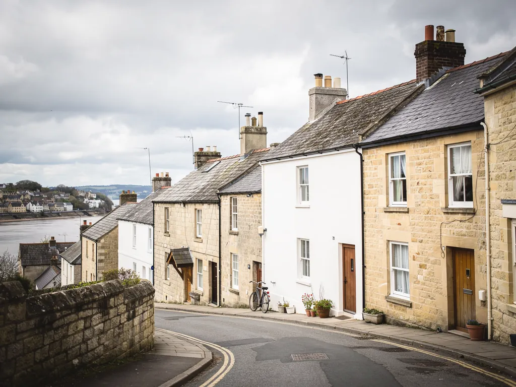 Stone houses on a steep street by a river town